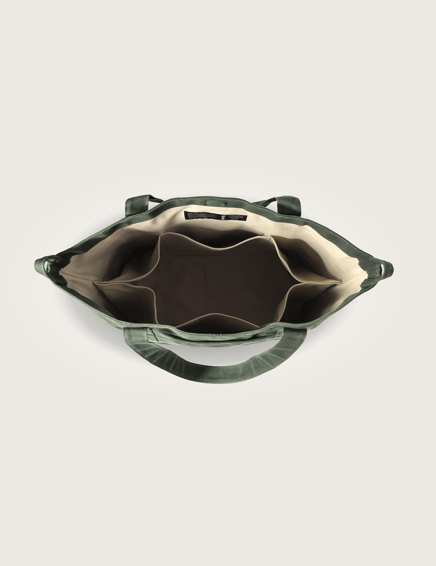 Green bag with interior lining on a light gray background