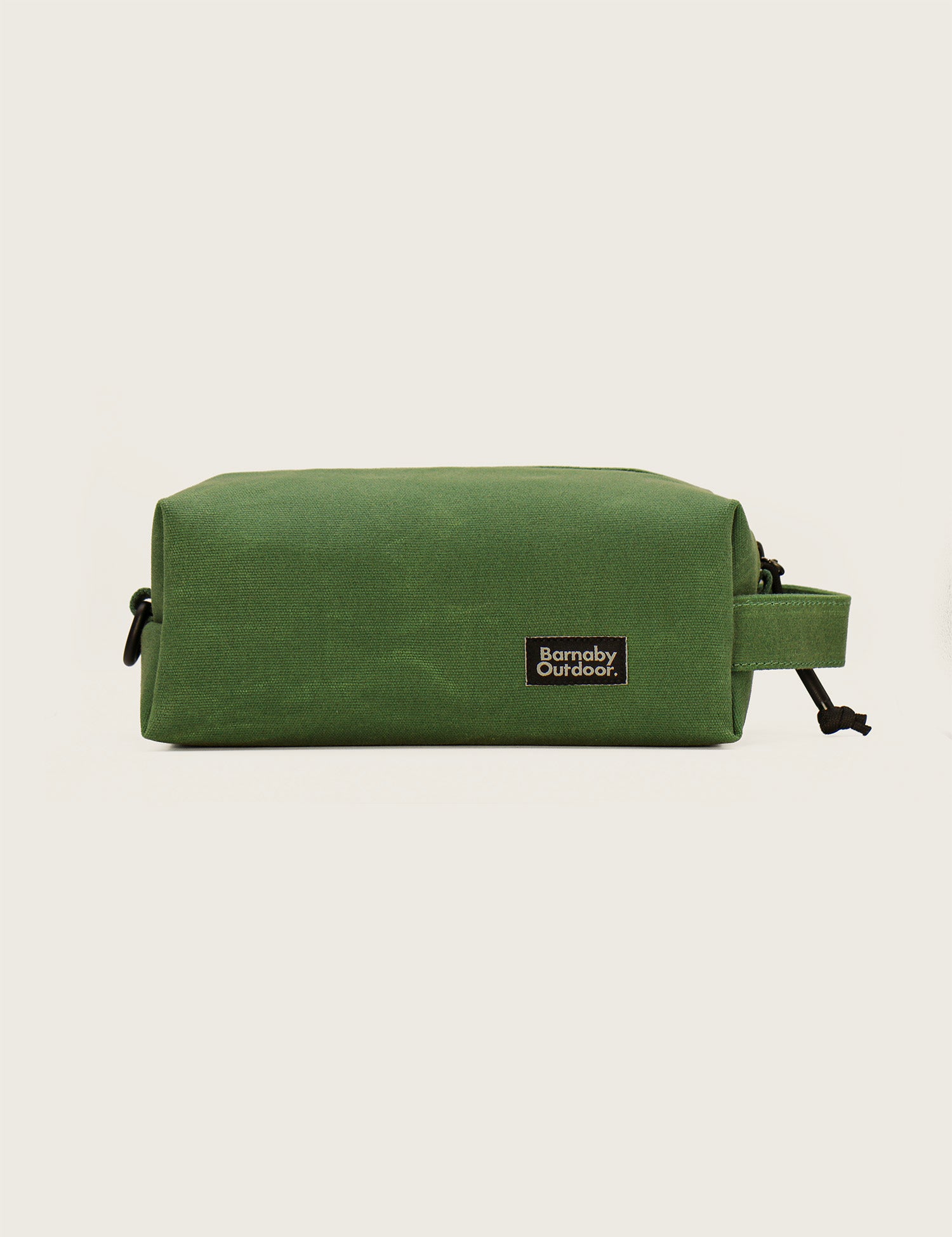 Green toiletry bag with a visible brand logo on a light gray background